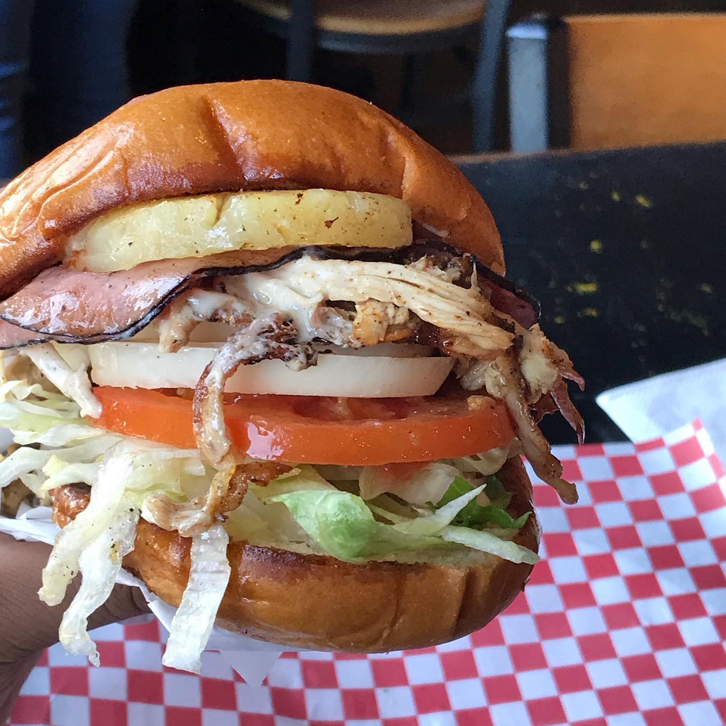 Made with shredded rotisserie chicken, ham, pineapple slice, cheese, lettuce, tomato, mayo, and topped with BBQ sauce. Served on artisan bread.